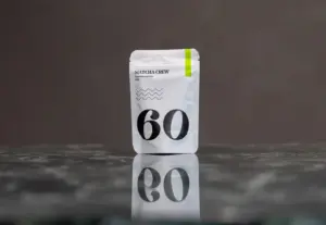 White Matcha Crew No. 60 Premium Matcha 40 g pouch reflected on a dark tabletop