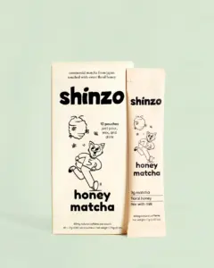 Shinzo Honey Matcha box beside a single cream-colored pouch on a pale green background
