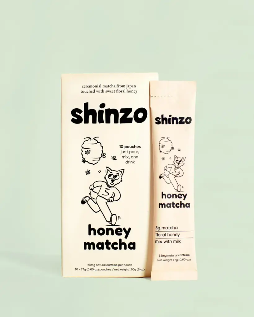 Shinzo Honey Matcha box beside a single cream-colored pouch on a pale green background