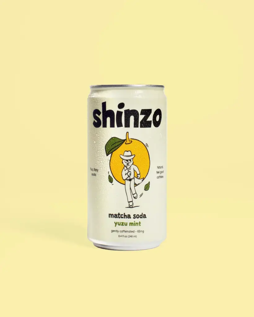 Shinzo yuzu mint matcha soda can against a pale yellow background