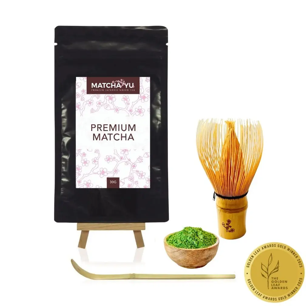 Matcha Yu Tea 30 g matcha pouch with bamboo whisk, scoop, bowl of green powder, and gold award badge