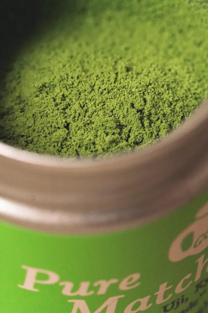Close-up of green matcha powder inside an open Golde Pure Matcha tin