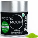 Matcha Moon Pure Zen ceremonial matcha tin beside a small mound of green powder