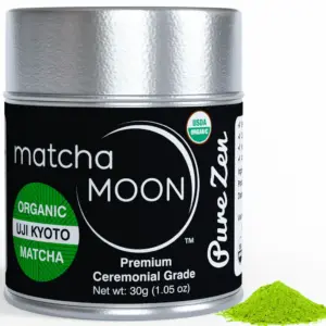 Matcha Moon Pure Zen ceremonial matcha tin beside a small mound of green powder