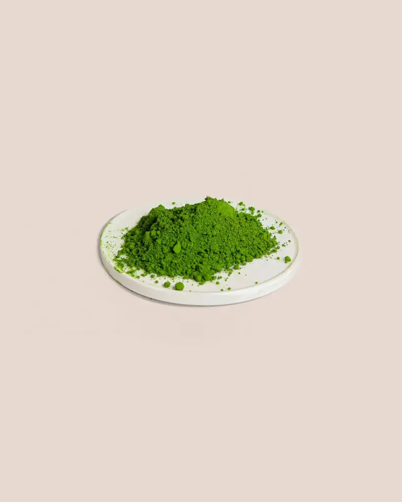 Mound of green matcha powder on a round white plate
