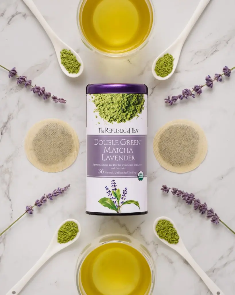 Double Green Matcha Lavender tin surrounded by tea, matcha powder, tea bags, and lavender sprigs