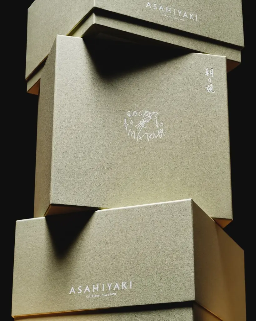 Stacked olive-green Asahiyaki boxes with white lettering