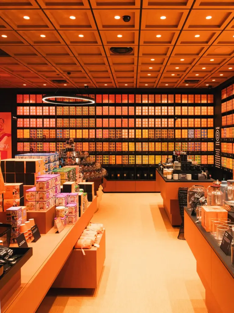 Orange-lit tea store with shelves of colorful T2 boxes