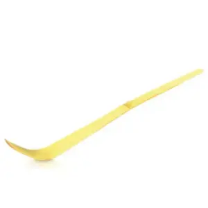 Pale bamboo chashaku with a curved scoop on a white background