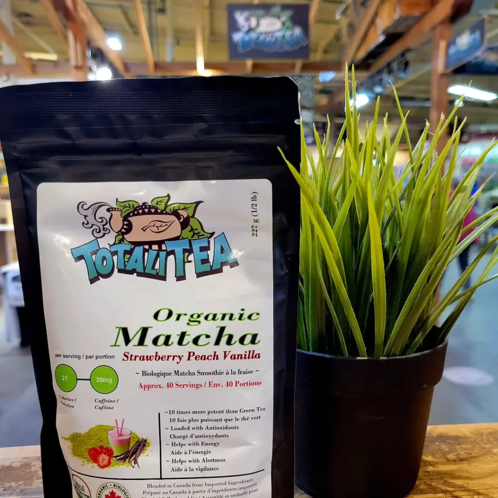 Black TotaliTea matcha pouch beside a potted green plant