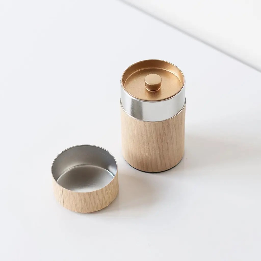 Open cylindrical wood-grain canister with silver interior and gold inner lid